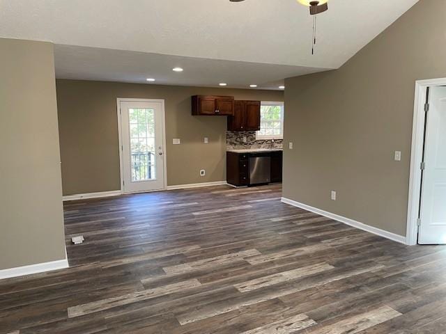 unfurnished living room with dark wood finished floors, recessed lighting, ceiling fan, and baseboards
