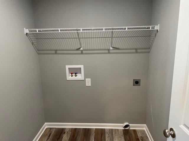 laundry area with dark wood-type flooring, hookup for a washing machine, and electric dryer hookup