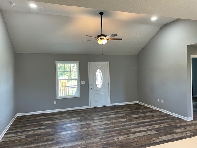 entrance foyer with ceiling fan, vaulted ceiling, and dark wood-type flooring