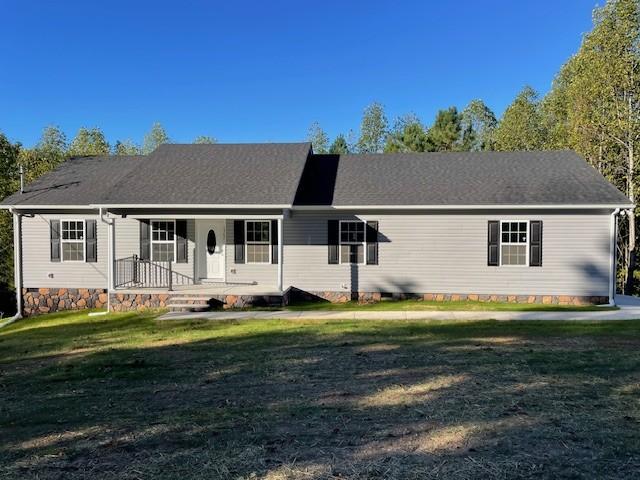 view of front of house featuring covered porch, a front yard, and crawl space
