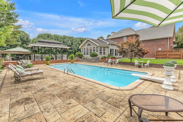 view of pool featuring a patio and a diving board