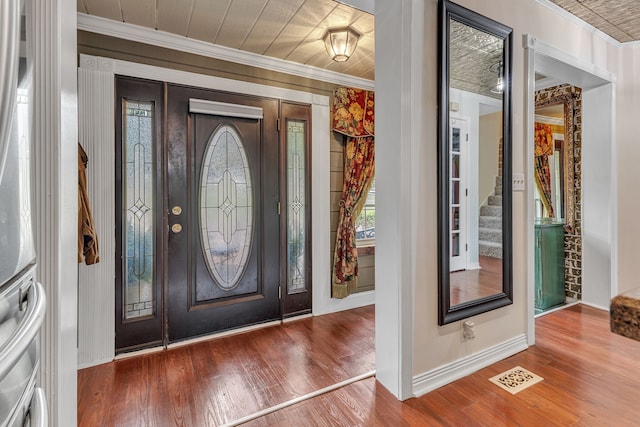 foyer featuring wood-type flooring and ornamental molding