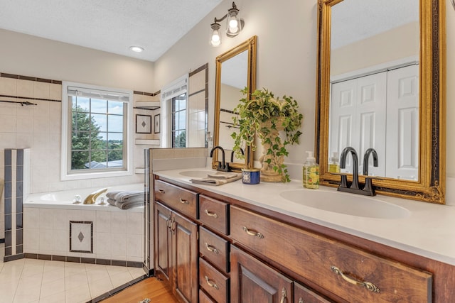 bathroom featuring double vanity, a textured ceiling, and wood-type flooring