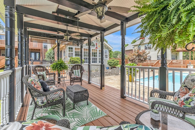 sunroom / solarium featuring beam ceiling and ceiling fan