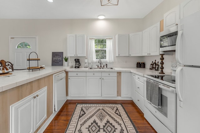 kitchen with sink, wood-type flooring, white appliances, and white cabinets