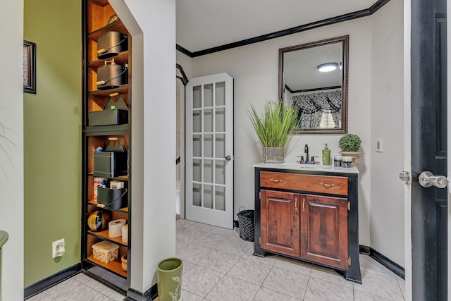 interior space featuring tile patterned floors, vanity, a textured ceiling, and ornamental molding