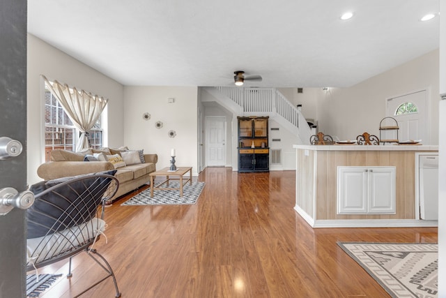 living room featuring ceiling fan and hardwood / wood-style floors