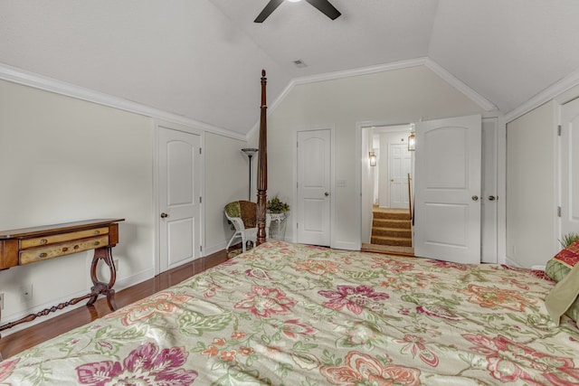 bedroom with lofted ceiling, dark wood-type flooring, crown molding, and ceiling fan