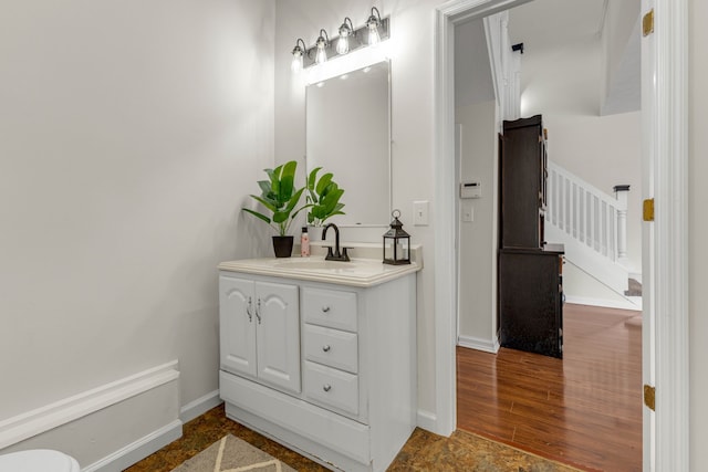 bathroom with hardwood / wood-style flooring and vanity