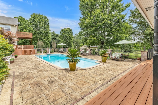 view of swimming pool featuring a deck and a patio area