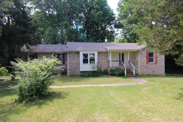 single story home featuring a porch and a front yard