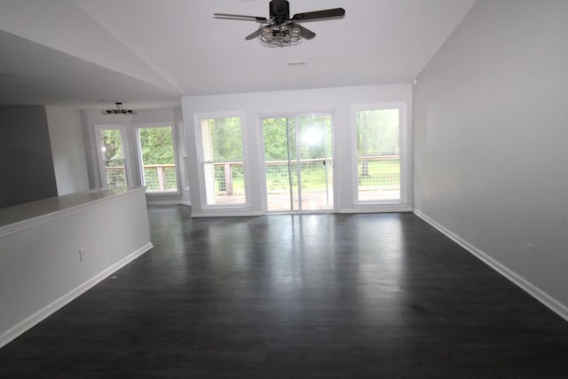 unfurnished room with ceiling fan with notable chandelier, dark hardwood / wood-style flooring, and lofted ceiling