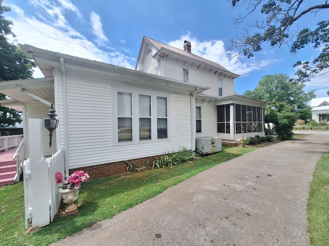 view of side of home with a sunroom