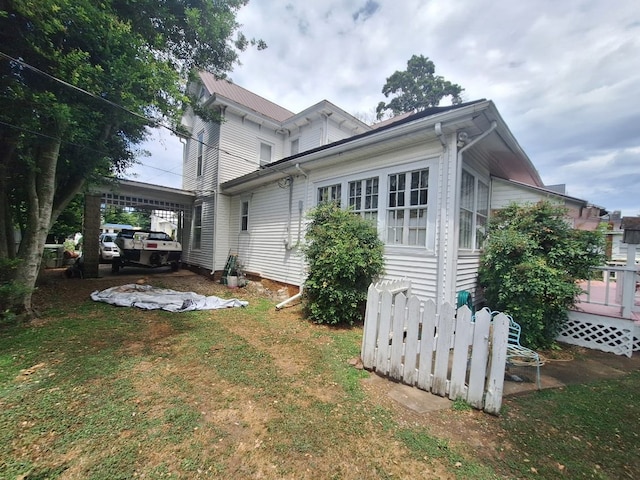 back of house with a carport