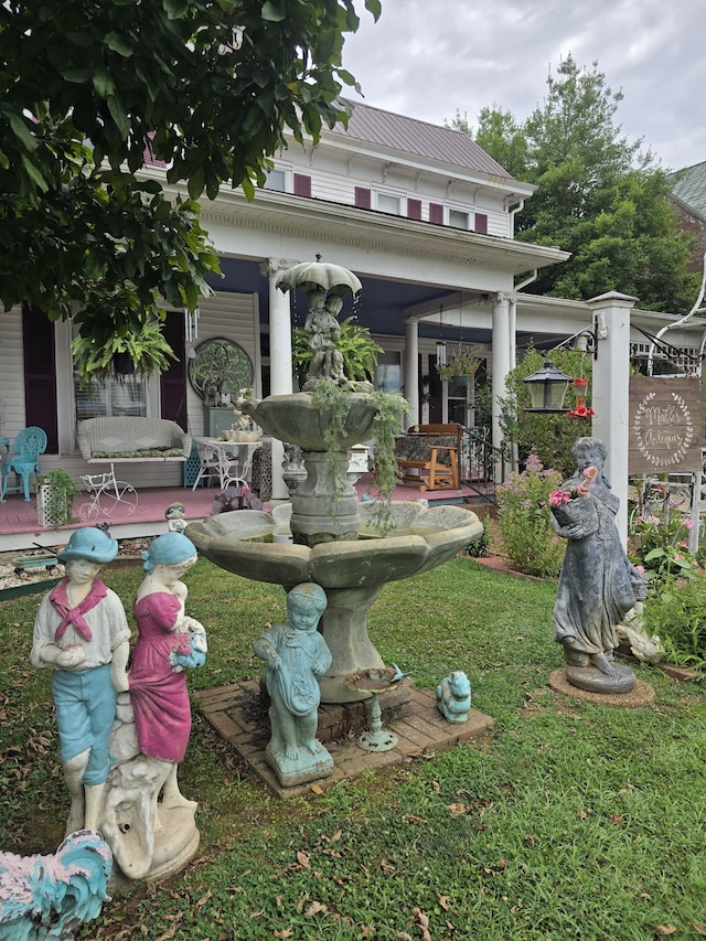 view of yard featuring covered porch