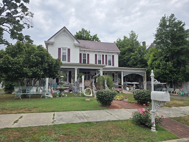 view of front of property with a porch and a front yard