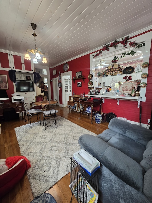 living room featuring wood ceiling, hardwood / wood-style flooring, and crown molding