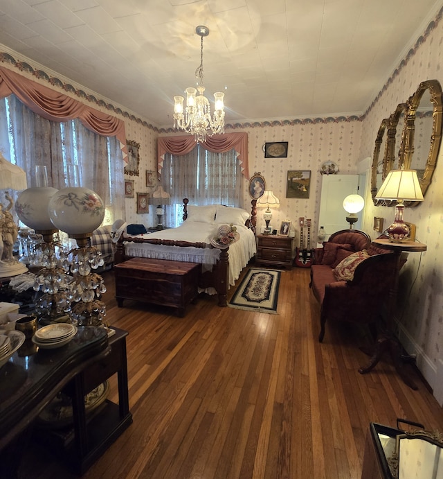 bedroom with an inviting chandelier and hardwood / wood-style flooring