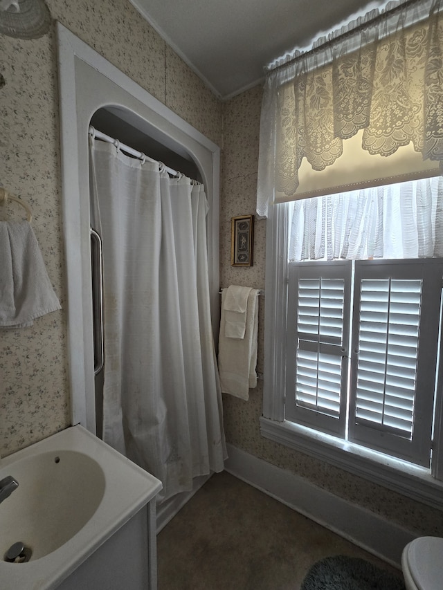 bathroom featuring vanity, toilet, and ornamental molding