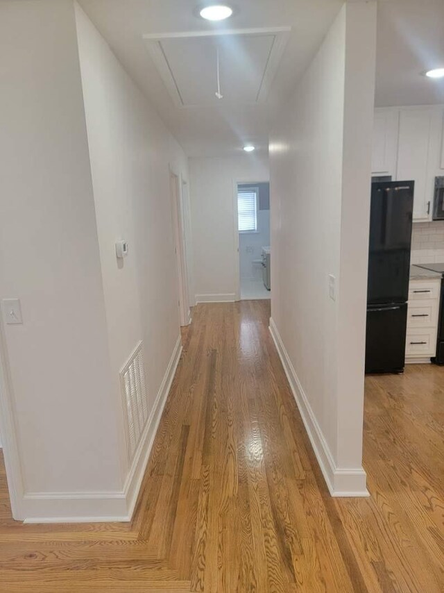 hallway with light wood-type flooring