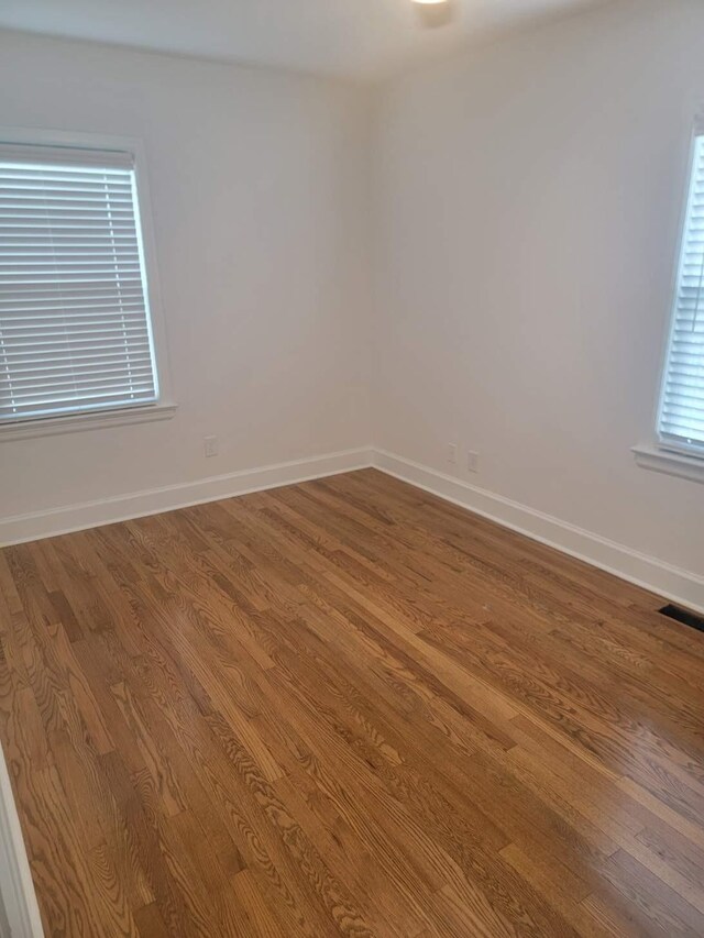 empty room with hardwood / wood-style flooring