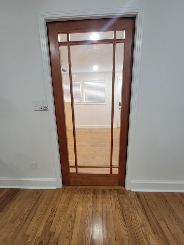 hallway with light hardwood / wood-style flooring