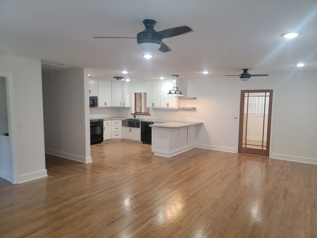 unfurnished living room featuring ceiling fan, sink, and wood-type flooring