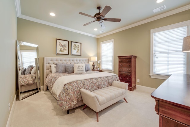 bedroom with light colored carpet, ceiling fan, and crown molding