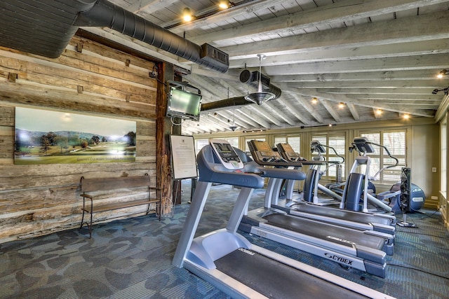 gym with carpet flooring, lofted ceiling, wooden ceiling, and wooden walls