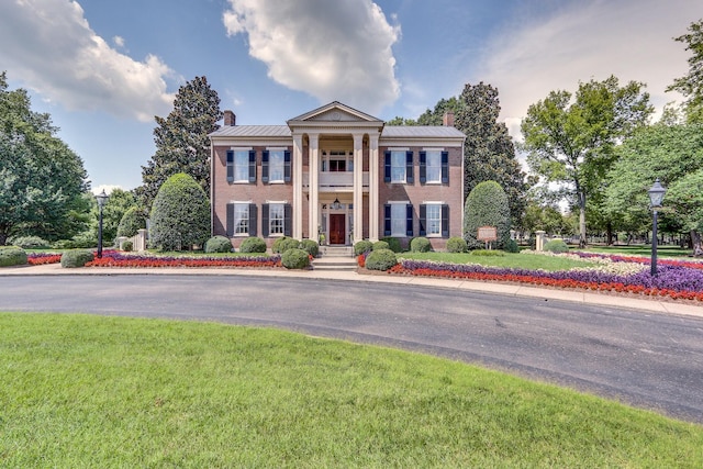 neoclassical / greek revival house with a front yard