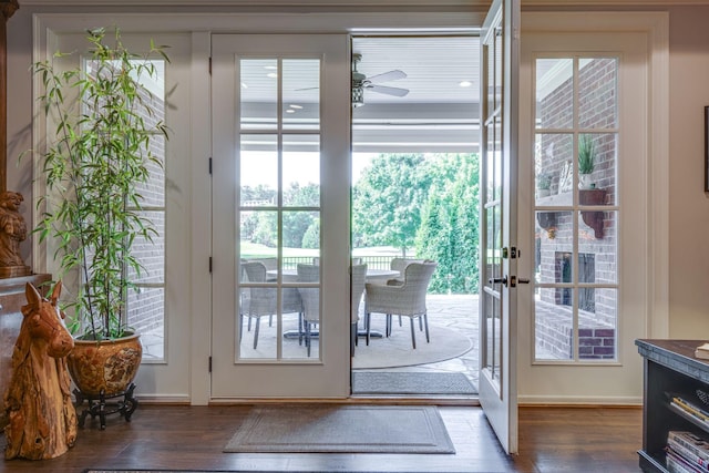 doorway to outside with dark hardwood / wood-style floors, ceiling fan, and french doors