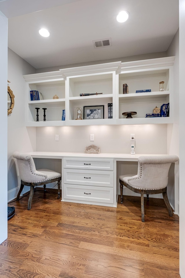 office area featuring built in desk and wood-type flooring