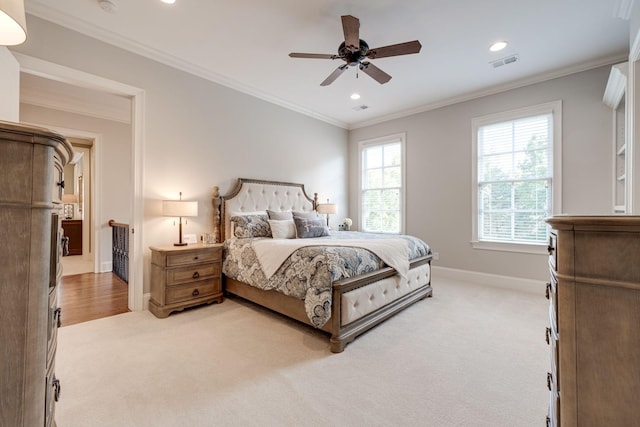 carpeted bedroom with ceiling fan and ornamental molding