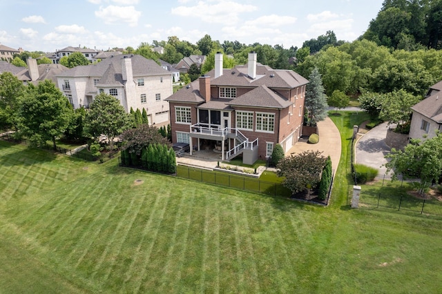 rear view of house featuring a wooden deck and a yard