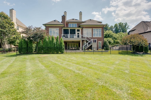 rear view of house with a lawn