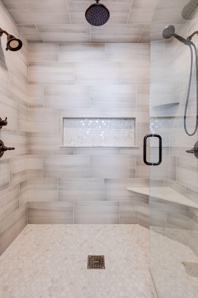 bathroom featuring a shower with door