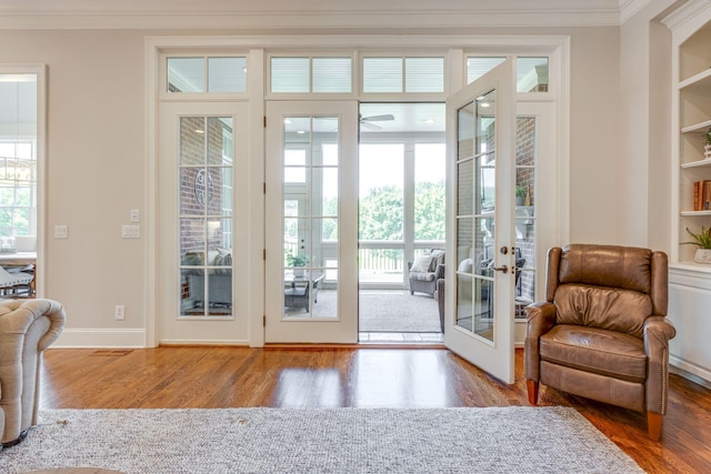 doorway with ceiling fan, french doors, wood-type flooring, and built in features