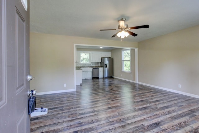 unfurnished living room featuring ceiling fan, hardwood / wood-style floors, and sink