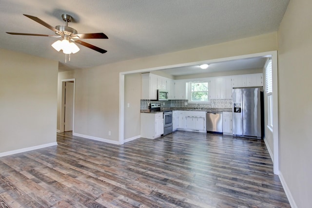 kitchen with white cabinetry, dark hardwood / wood-style flooring, ceiling fan, and appliances with stainless steel finishes