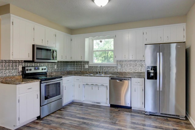 kitchen featuring dark hardwood / wood-style flooring, stainless steel appliances, white cabinetry, and sink