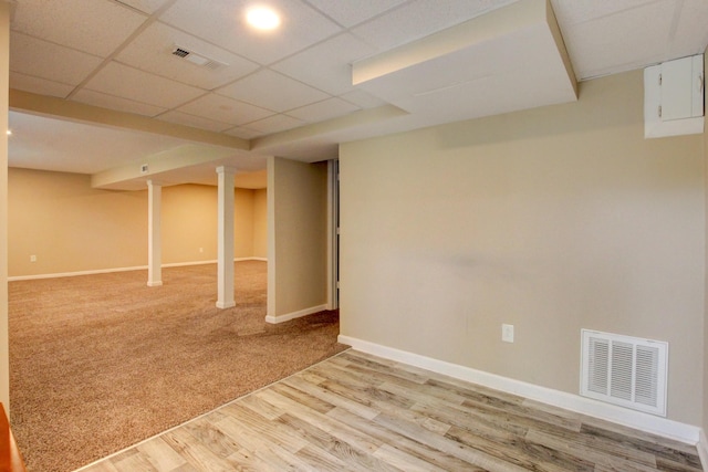 basement with wood-type flooring and a drop ceiling