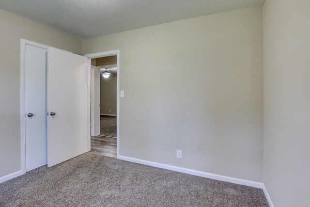 unfurnished bedroom with carpet floors and a textured ceiling