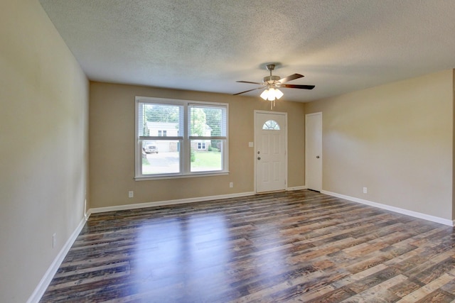 interior space with ceiling fan, dark hardwood / wood-style flooring, and a textured ceiling