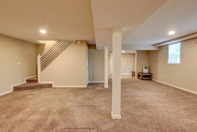 basement featuring light colored carpet