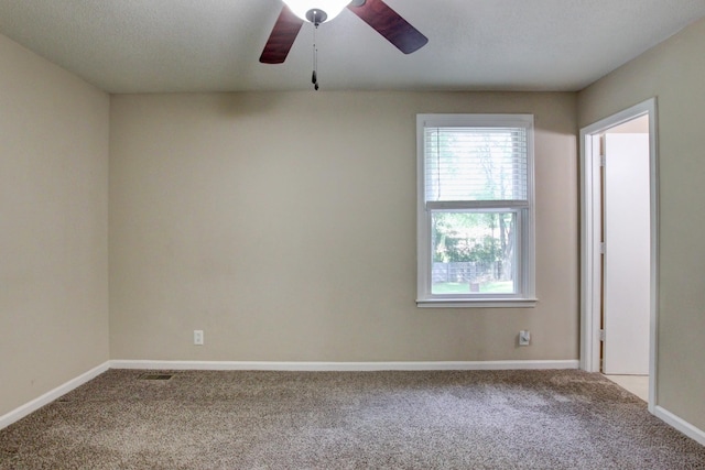 spare room featuring carpet flooring and ceiling fan