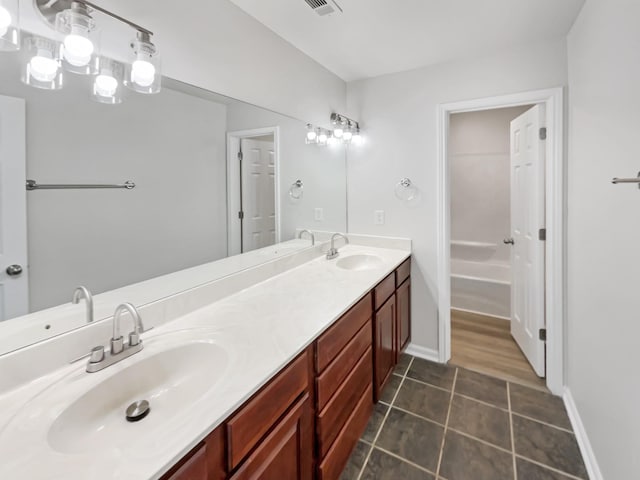 bathroom featuring vanity and a washtub