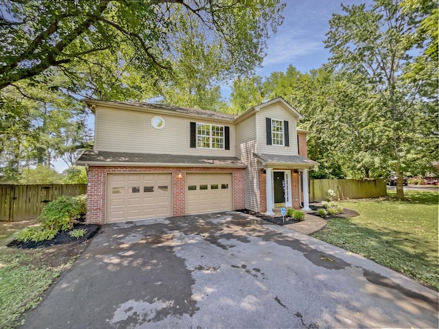 view of property featuring a front yard and a garage