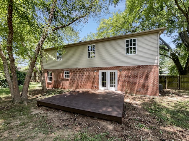 back of property with french doors, a deck, and cooling unit