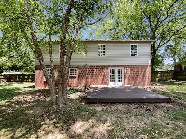 rear view of property featuring a yard and a deck