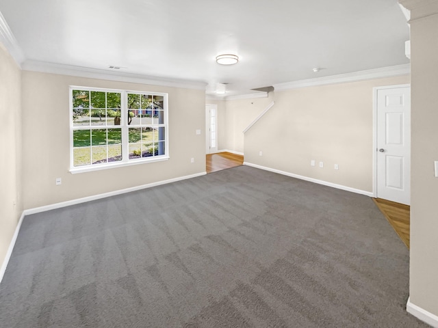 unfurnished living room featuring dark carpet and ornamental molding